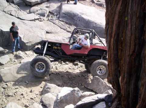 1989 Ford Bronco - A modified off-road vehicle navigates a challenging rocky landscape.