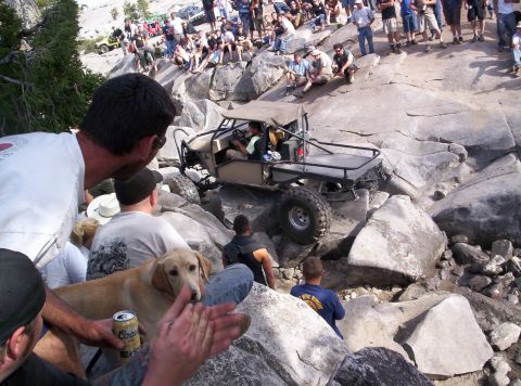 1989 Ford Bronco - A custom off-road buggy tackles a challenging rock crawling course with a crowd of onlookers.