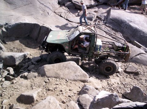 1989 Ford Bronco - An off-road vehicle attempts to traverse a challenging rocky obstacle course.