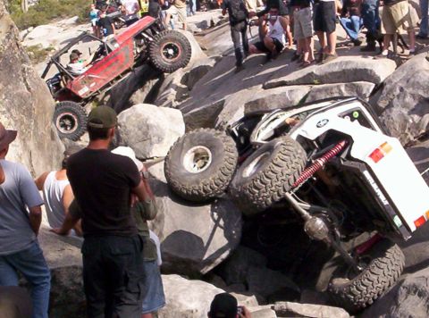 1989 Ford Bronco - Off-road vehicles tackle a challenging rocky terrain with onlookers observing the action.