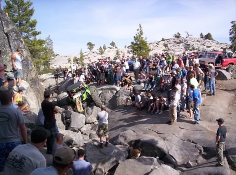 1989 Ford Bronco - A crowd gathers to watch an off-road vehicle navigate a challenging rocky terrain.