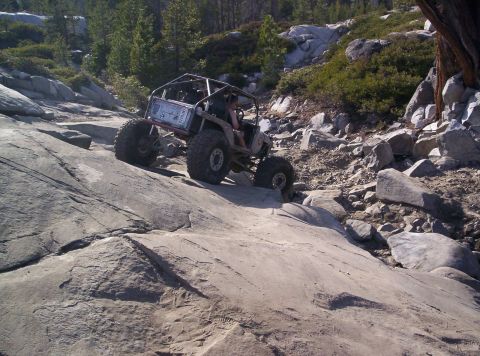 1989 Ford Bronco - This heavily modified off-road vehicle navigates a challenging rocky terrain.