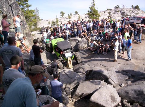 1989 Ford Bronco - Spectators gather to watch an off-road buggy navigate a rocky terrain.