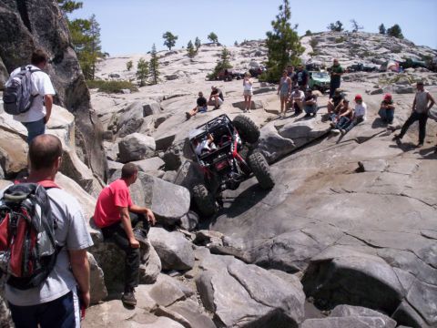 1989 Ford Bronco - Spectators gather to watch an off-road buggy tackle a challenging rocky incline.