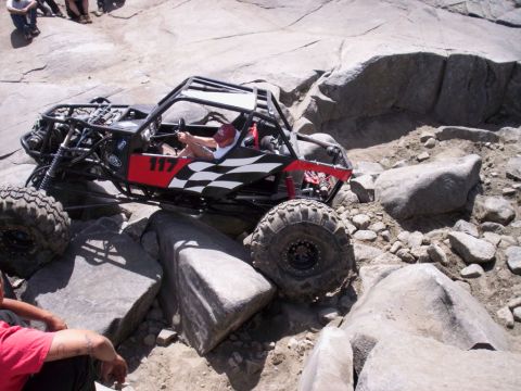 1989 Ford Bronco - This custom off-road buggy navigates a challenging rocky course, demonstrating its extreme suspension and tire capabilities.