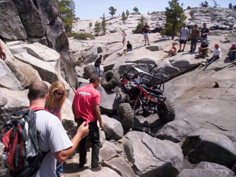 1989 Ford Bronco - A group of people watch as a custom off-road buggy navigates a rocky trail.