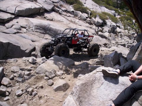 1989 Ford Bronco - This custom buggy navigates a challenging rocky trail, demonstrating its off-road capabilities.