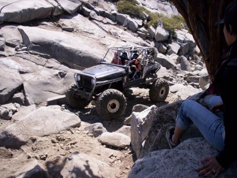 1989 Ford Bronco - A heavily modified off-road vehicle traverses a challenging rocky path.