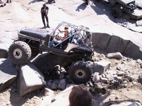 1989 Ford Bronco - This heavily modified Jeep is designed for extreme off-roading, tackling large rocks on a trail.