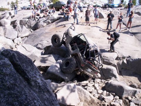 1989 Ford Bronco - A group of spectators watches as an off-road vehicle navigates a difficult rocky terrain.
