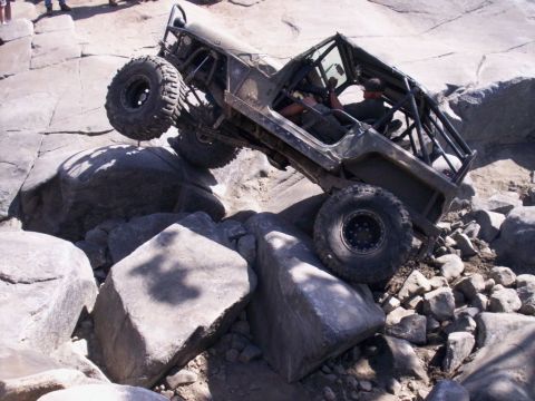 1989 Ford Bronco - This heavily modified off-road vehicle navigates a challenging rocky terrain.