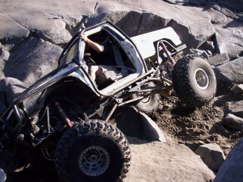 1989 Ford Bronco - An off-road vehicle attempts to traverse a challenging rocky landscape.