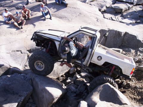1989 Ford Bronco - Off-road vehicle attempts to traverse a challenging rocky obstacle course.