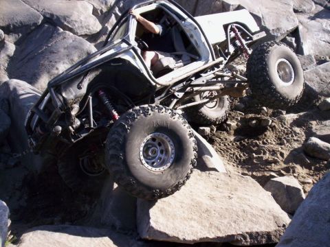 1989 Ford Bronco - This heavily modified off-road vehicle navigates a challenging rocky terrain.