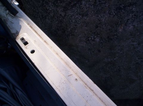 1989 Ford Bronco - A close-up view of a vehicle's frame rail, showing wear and tear.