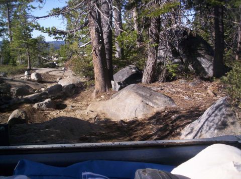 1989 Ford Bronco - View from inside a vehicle shows a , off-road trail winding through trees and large rocks.