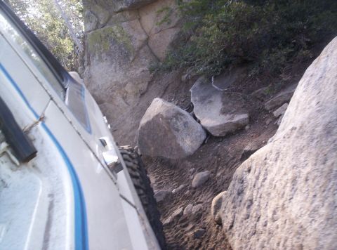 1989 Ford Bronco - Navigating a tight spot on a trail requires careful maneuvering.