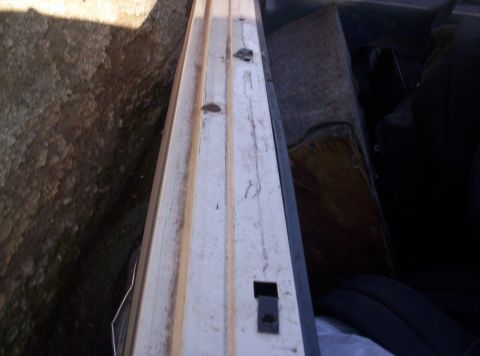 1989 Ford Bronco - Close-up of a vehicle's interior door panel and seat, showing wear and tear.