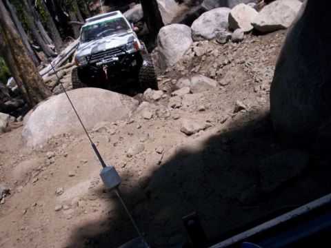 1989 Ford Bronco - An off-road SUV navigates a rocky trail, demonstrating its capability on challenging terrain.