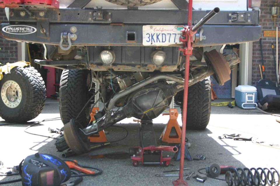 Ford Bronco rear axle being worked on, jacked up with tools around it