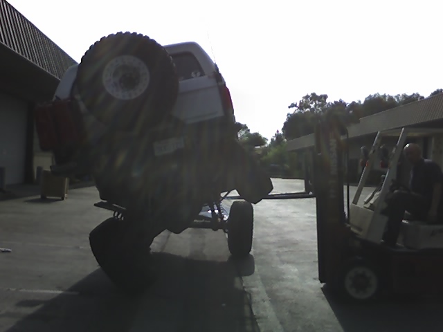 1995 Ford Bronco upside down on forklift