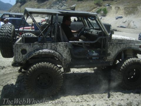 1987 Suzuki Samurai - This heavily modified off-road vehicle is covered in mud after a day of driving on a dirt trail.