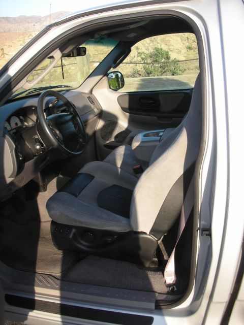 1998 Ford Crown Victoria - Interior view of a truck's driver seat and dashboard, showing the steering wheel and center console.