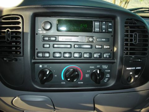 1998 Ford Crown Victoria - The interior dashboard features a radio, climate controls, and passenger airbag indicator.