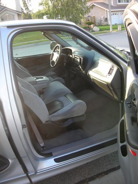 1998 Ford Crown Victoria - Interior of a pickup truck, likely from the late 1990s, with cloth seats and a center console.