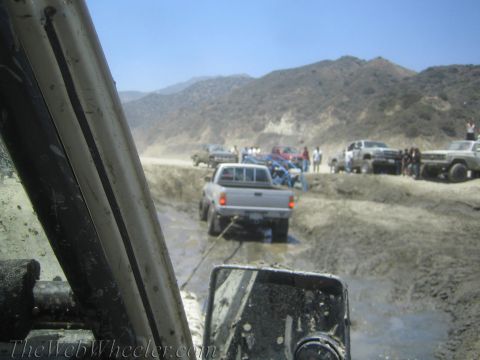 1987 Suzuki Samurai - Multiple vehicles are stuck in the mud during an off-road excursion.