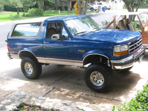 1996 Ford Bronco - This lifted Ford Bronco has a two-tone paint scheme and large off-road tires.