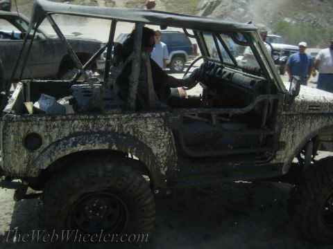 1987 Suzuki Samurai - This heavily mud-splattered vehicle appears to be an off-road buggy, not a 1987 Suzuki Samurai.