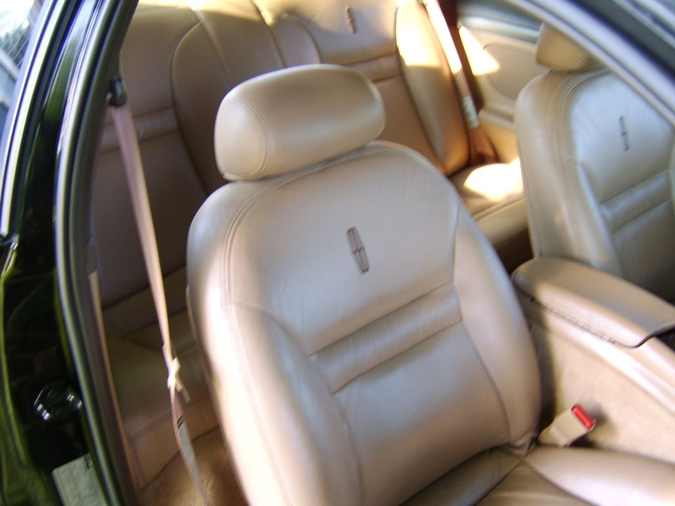 Tan leather car seat with Lincoln logo, interior view