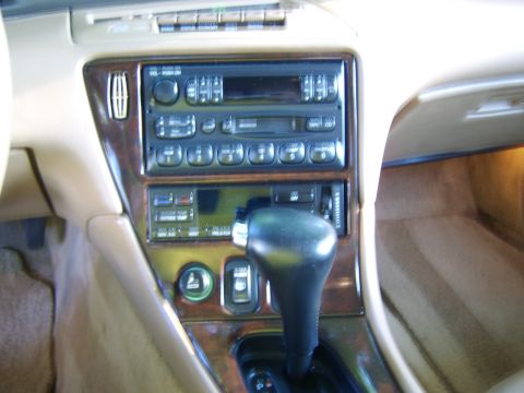 1996 Mercury Grand Marquis - Close-up of a car's center console, showing the radio and climate control panel.