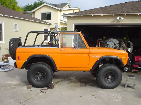 1977 Ford Bronco - This 1977 Ford Bronco is shown in a side profile, a prominent roll cage and a spare tire mounted on the back.