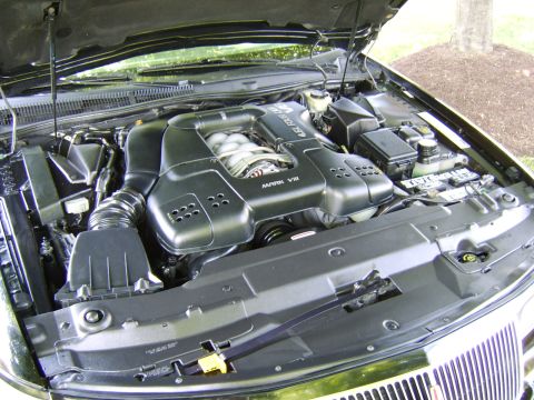 1996 Mercury Grand Marquis - The engine bay of a vehicle, a V8 engine cover with 'MARK VIII' visible.