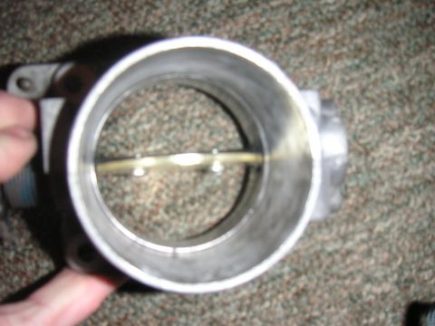 1996 Ford Crown Victoria - Close-up view of a throttle body, showing the internal butterfly valve.