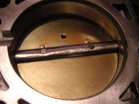 1996 Ford Crown Victoria - Throttle body interior view, showing the butterfly valve and shaft.