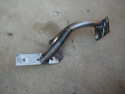 1996 Ford Bronco - Custom metal bracket for a skid plate, shown on a concrete surface.