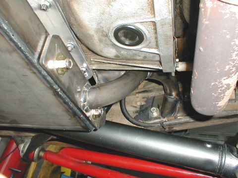 1996 Ford Bronco - Custom exhaust piping and a skid plate are visible on the underside of a vehicle.