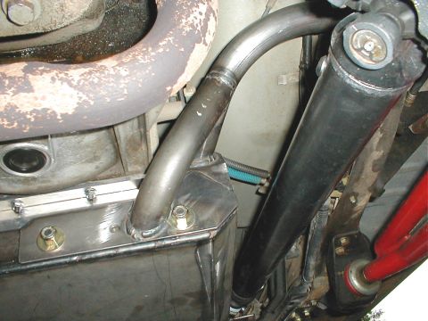 1996 Ford Bronco - Close-up view of the undercarriage components, including the exhaust system and driveshaft.