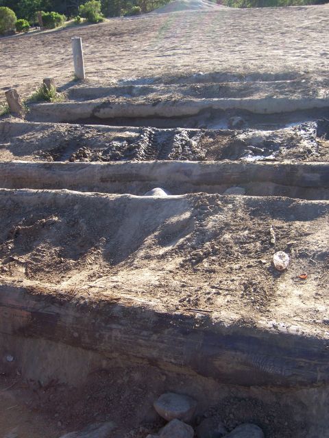 1991 Ford Bronco - Tire tracks are visible in the muddy, rutted terrain.