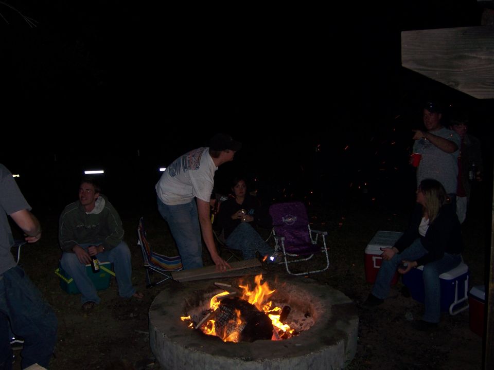 People gathered around a campfire at night
