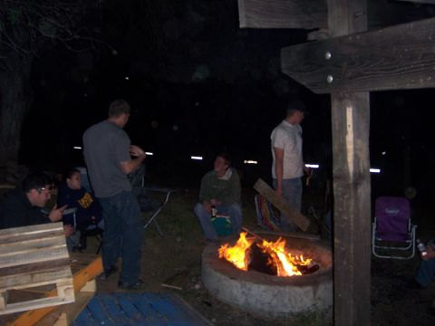1991 Ford Bronco - A group of people gather around a fire pit during an evening outdoor event.