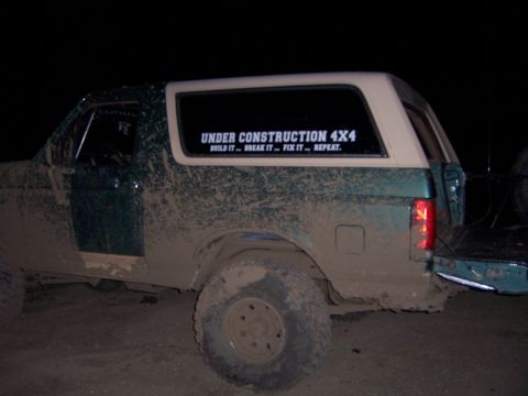 1991 Ford Bronco - Muddy 1991 Ford Bronco, rear view, with 'Under Construction 4x4' decal.