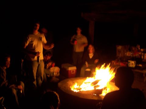 1991 Ford Bronco - Friends gather around a blazing campfire, enjoying the warmth and camaraderie on a dark night.