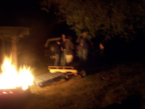 1991 Ford Bronco - Gathering around a campfire at night with a vehicle nearby.