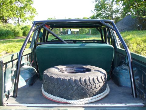 1978 Ford Bronco - Spare tire and roll cage visible in the cargo area of a 1978 Ford Bronco.