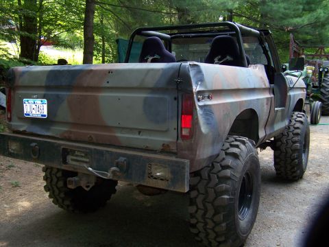 1979 Ford Bronco - This modified off-road vehicle, likely a 1978 model, features a camouflage paint scheme and aftermarket racing seats.