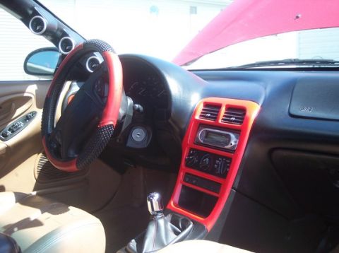 1996 Ford Probe - Interior view of a car's dashboard, showing the steering wheel, center console, and aftermarket stereo system.